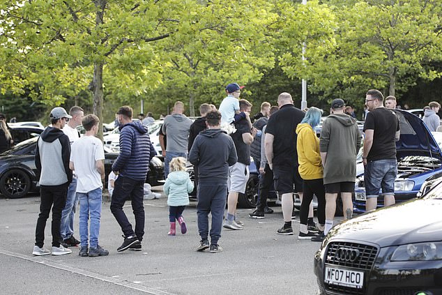 Boy races and car enthusiasts ignore social distancing during a meet up at the Phoenix Park tram stop in Nottinghamshire on August 2