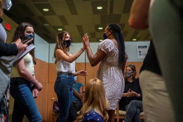 Many teenagers see the Covid shot as unlocking freedoms denied to them during the pandemic. In New Orleans, Ava Kreutziger, 14, left, high-fives Croix Hill, 15, after Croix received her first dose.