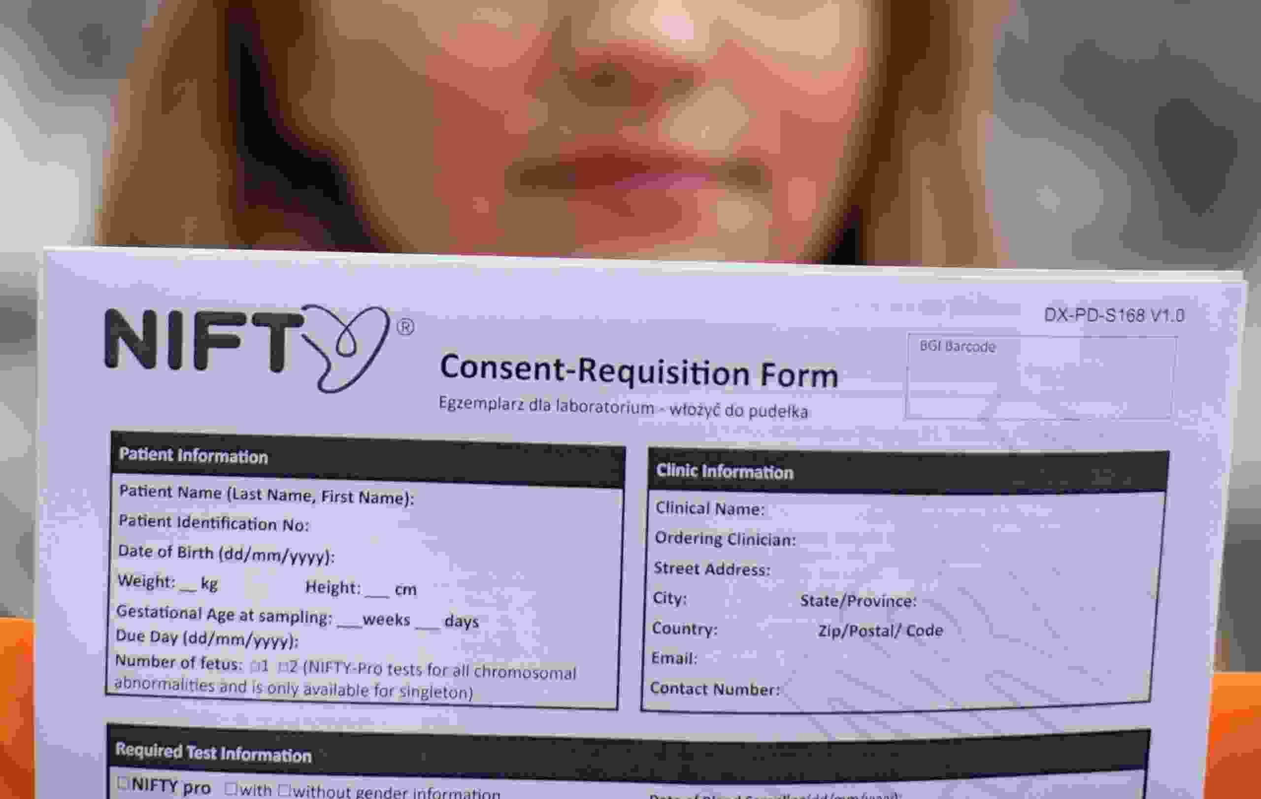 Office administrator Emilia, who requests that only her first name be used, and had taken Chinese gene firm BGI Group’s NIFTY prenatal test, holds a blank copy of the test’s consent form in Warsaw, Poland, March 30, 2021.